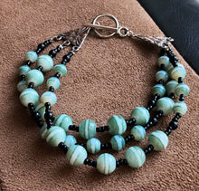 Load image into Gallery viewer, Multi-stranded black and green bracelet

